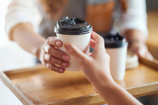 handing over a cup of coffee
